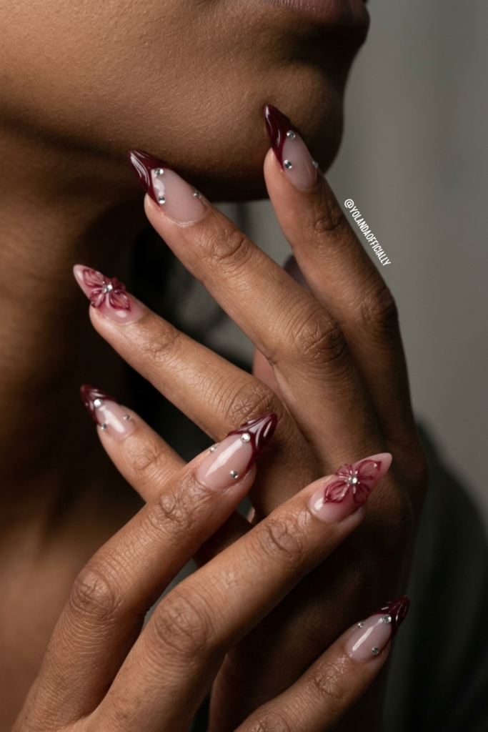 Burgundy French Tip Press-On Nails With 3D Flower Elegant burgundy french tip press-on nails with 3D flower detail and rhinestones on almond shaped nails